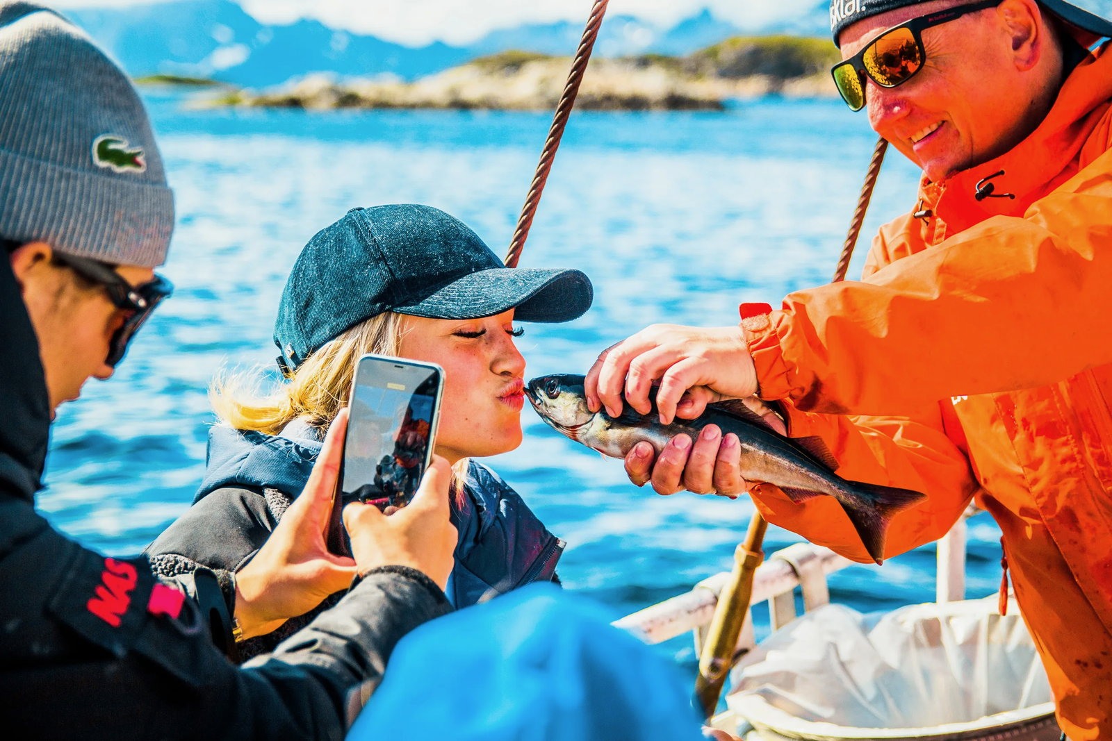 Girl kissing fish lofoten fishing trip xxlofoten 2020